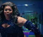 Lizzo in sequins, dancing in front of a hallway with a light-up floor