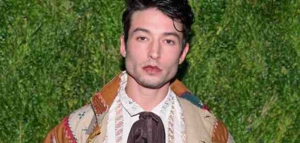 Actor Ezra Miller stares at the camera while wearing neutral coloured clothing