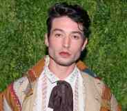 Actor Ezra Miller stares at the camera while wearing neutral coloured clothing