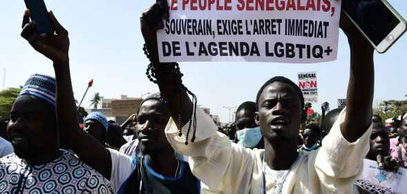 A protester in Dakar holds a sign reading 'No to LGBTQ+ agenda'.