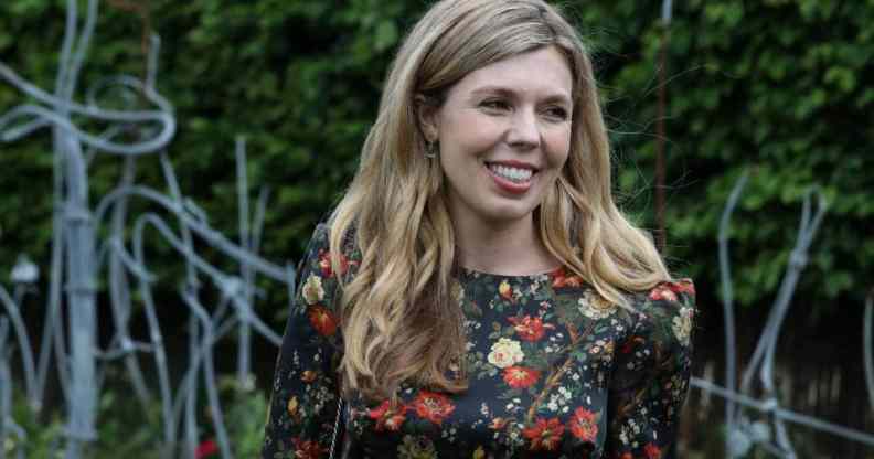 Carrie Johnson, the wife of prime minister Boris Johnson, wears a floral dress while standing outside