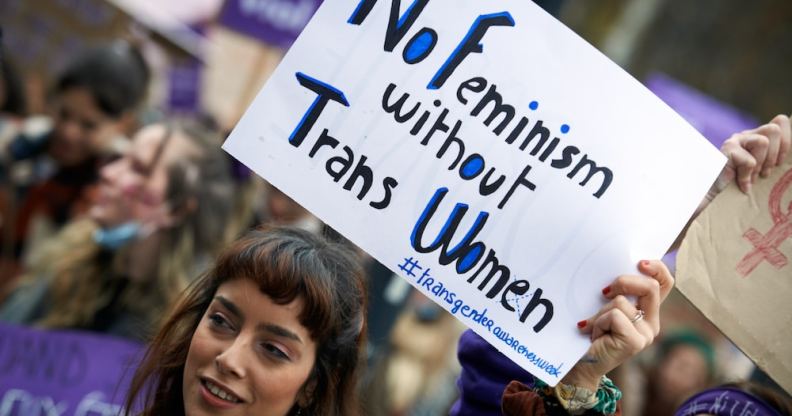 A protester holds a sign that reads: 'No feminism without trans women'
