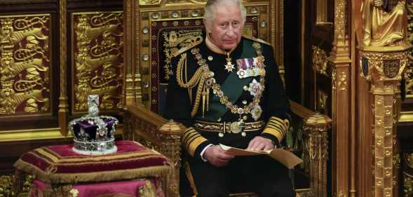 Prince Charles, Prince of Wales reads the Queen's speech next to her Imperial State Crown in the House of Lords Chamber