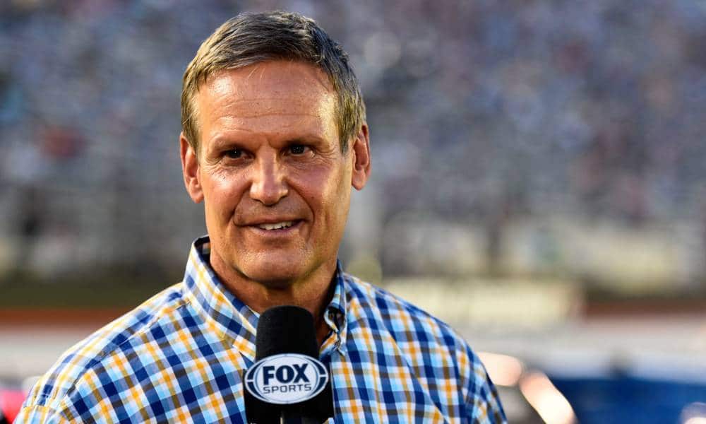 Tennessee governor Bill Lee speaks into a microphone during a sporting event