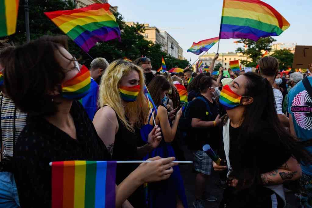 Women wear protective face masks with rainbow colour