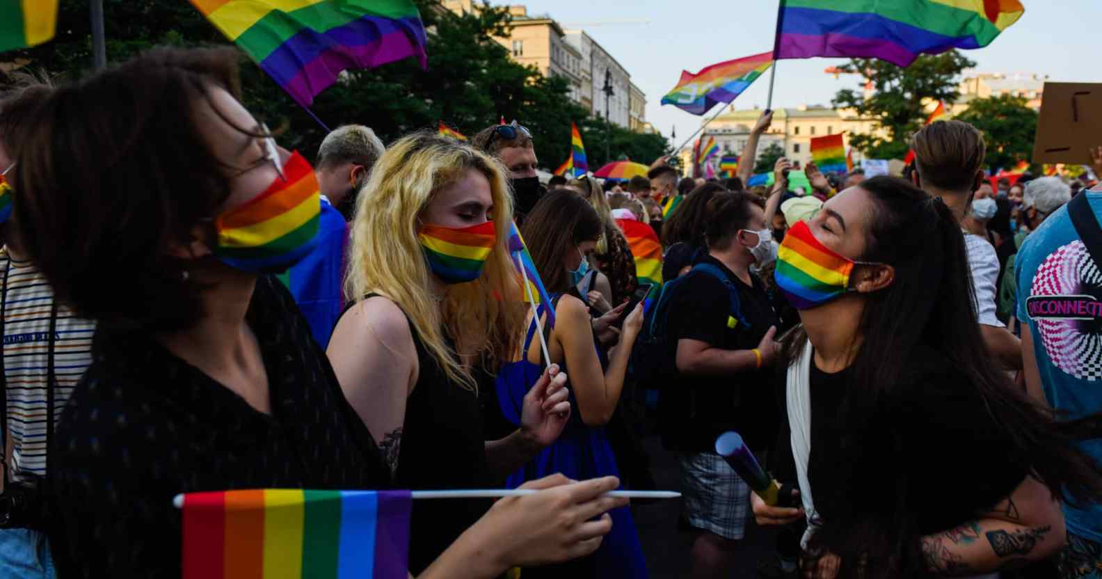 Women wear protective face masks with rainbow colour