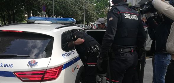 Nelson David MB is escorted to a police car by Basque police officers