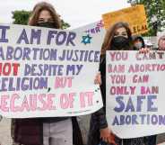 Marchers hold up signs during a Mother's Day rally in support of Abortion rights at the U.S. Supreme Court.