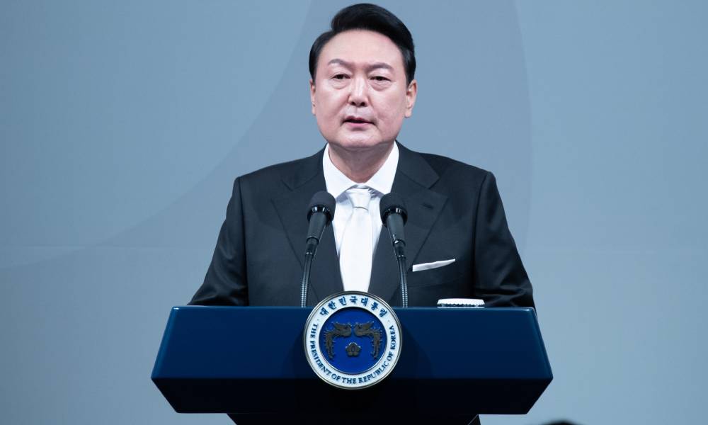 South Korean president Yoon Suk-yeol stands at a podium