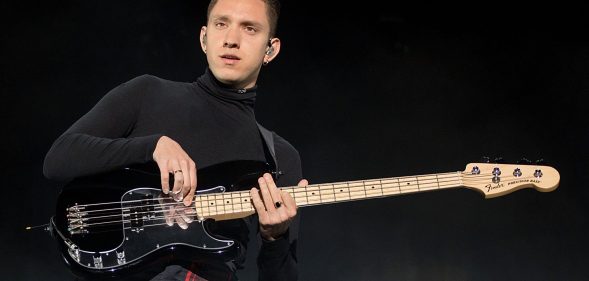 Oliver Sim of The xx performs on his bass guitar