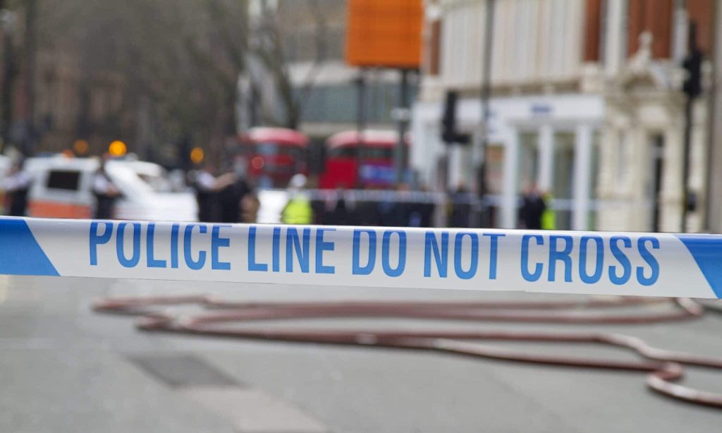 Police tape across a road