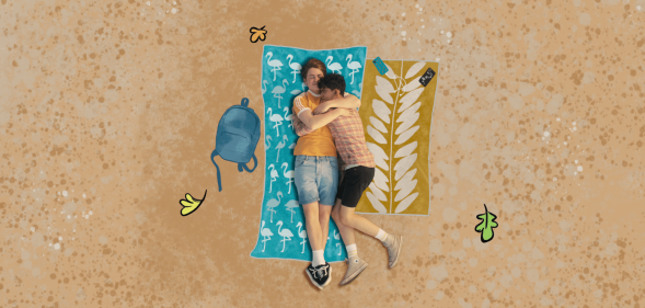 Still of Nick and Charlie hugging on the beach in Heartstopper