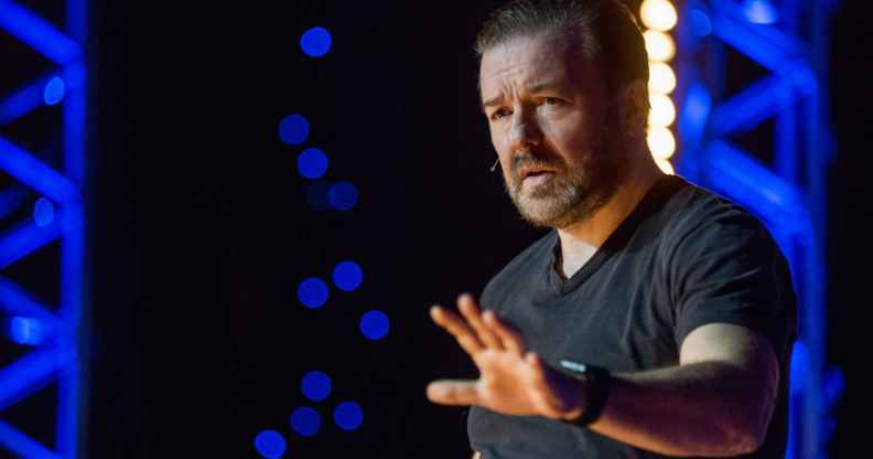 Ricky Gervais gestures while performing on stage