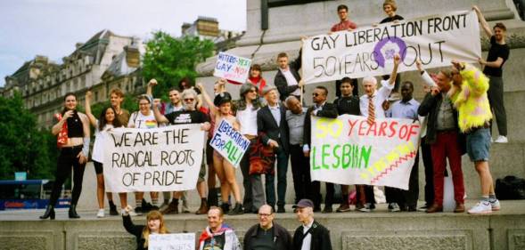 Members of the Gay Liberation Front (GLF) hold up signs during a protest in 2019