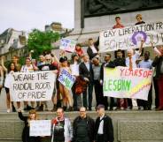 Members of the Gay Liberation Front (GLF) hold up signs during a protest in 2019