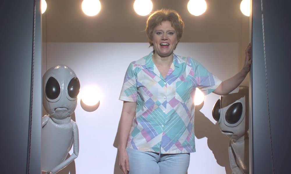 Kate McKinnon's character Colleen Rafferty bids farewell to Earth as she boards an alien spaceship on Saturday Night Live