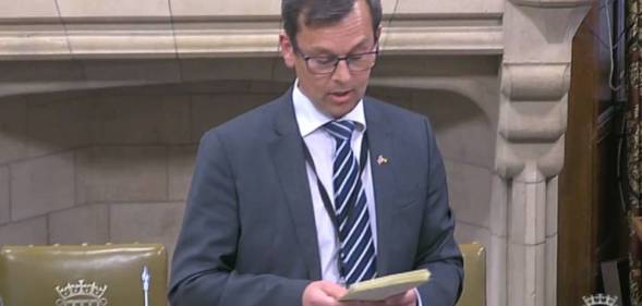Nick Fletcher, Conservative MP for Don Valley, wears a grey suit jacket, white shirt and blue striped tie during a parliament debate