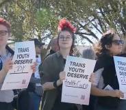 three people hold up signs that read "trans youth deserve joy", "trans youth deserve healthcare" and "trans youth deserve respect"