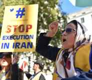A woman shouting with her first in the air, a person next to her holds a placard that reads 'stop execution in Iran'