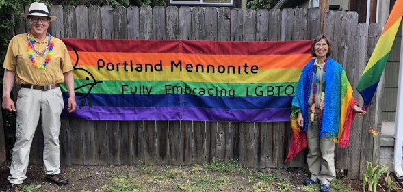 Members of the LGBTQ-inclusive Portland Mennonite Church with a Pride flag