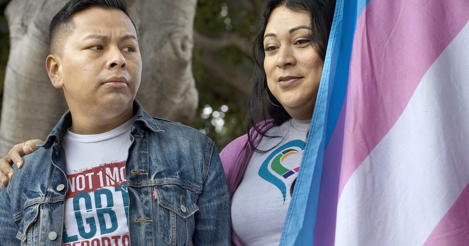 Jennicet Gutiérrez drapes herself with a trans Pride flag