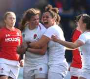 English women's rugby players cheer and shout on the field