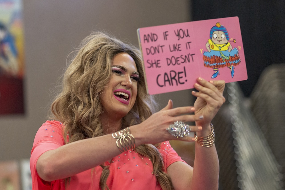 Drag queen Pickle reads from a book during a Drag Queen Story Hour event at the West Valley Regional Branch Library in Los Angeles, California