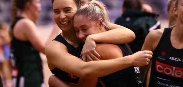Two netball players embrace