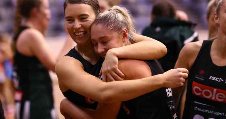 Two netball players embrace