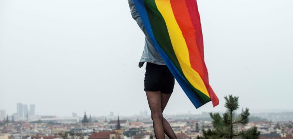 A participant waves a rainbow flag