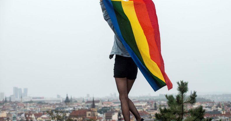 A participant waves a rainbow flag