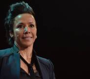 Dame Kelly Holmes wears a black top, black blazer and matching tie as she speaks to people off camera