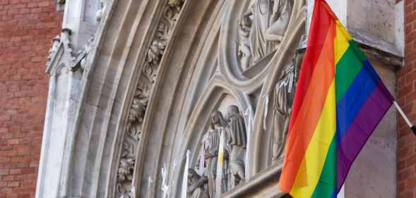 Pride flag flying from church building