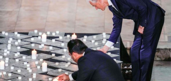 Norway's President of the Storting Masud Gharahkhani and Norway's Prime Minister Jonas Gahr Store light candles during a mourning service in Oslo Cathedral
