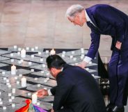 Norway's President of the Storting Masud Gharahkhani and Norway's Prime Minister Jonas Gahr Store light candles during a mourning service in Oslo Cathedral