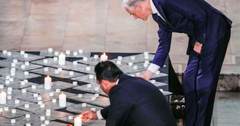 Norway's President of the Storting Masud Gharahkhani and Norway's Prime Minister Jonas Gahr Store light candles during a mourning service in Oslo Cathedral