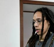 Brittney Griner wears a grey shirt and has her hair in locks as she walks to a preliminary court hearing in Russia