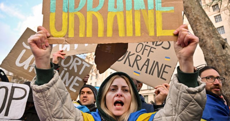 A Ukrainian person holds a sign reading "Ukraine" at a protest outside Downing Street against the recent invasion of Ukraine on February 24, 2022 in London, England.