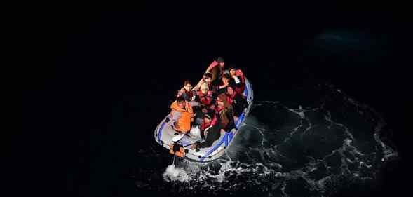 Turkish Coast Guard members intervene a boat carrying refugees, who were trying to go to Greek Islands, after being caught by the Turkish coast guards.