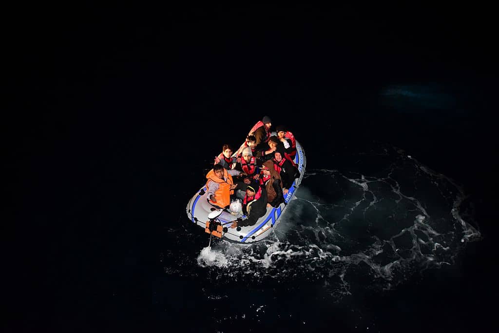 Turkish Coast Guard members intervene a boat carrying refugees, who were trying to go to Greek Islands, after being caught by the Turkish coast guards.