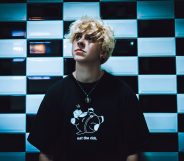 NOAHFINNCE against a wall of black and white checkerboard tiles