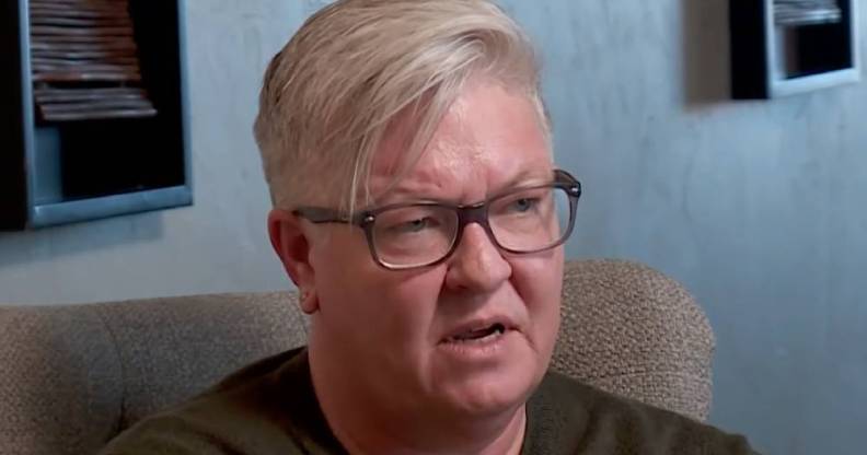 Oklahoma lesbian woman Kris Williams is seen talking to the news while wearing a grey shirt after she was removed from her son's birth certificate