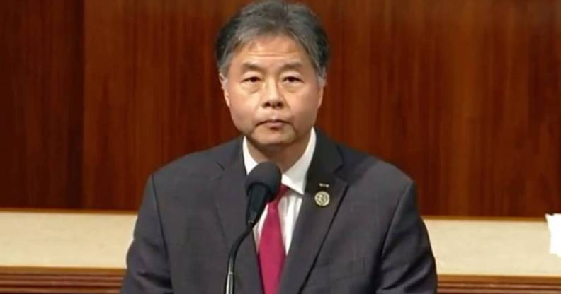 Ted Lieu, a Democrat lawmaker from California, stands at a podium before the state's House while wearing a white button up shirt, red tie and grey suit jacket