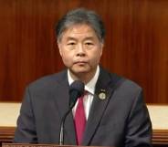 Ted Lieu, a Democrat lawmaker from California, stands at a podium before the state's House while wearing a white button up shirt, red tie and grey suit jacket