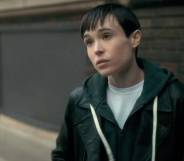 Elliot Page appears as his character from the Netflix show The Umbrella Academy. The character, Viktor, is wearing a white t-shirt and blue hooded sweatshirt as he stands outside and talks to someone off screen