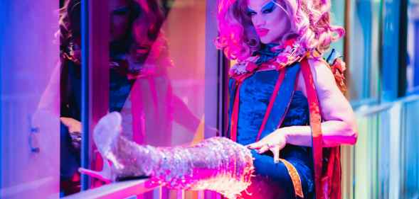 Glitzy Von Jagger poses along an armrest