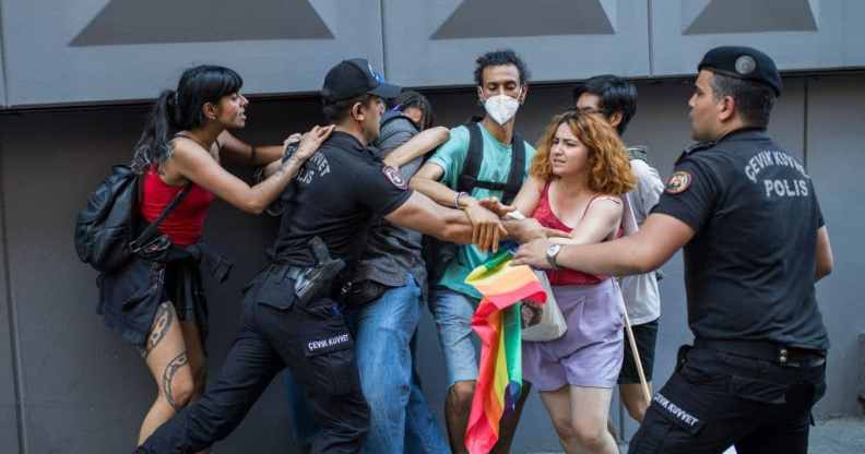 A Turkish policeman detains a demonstrator during a Pride march in Istanbul