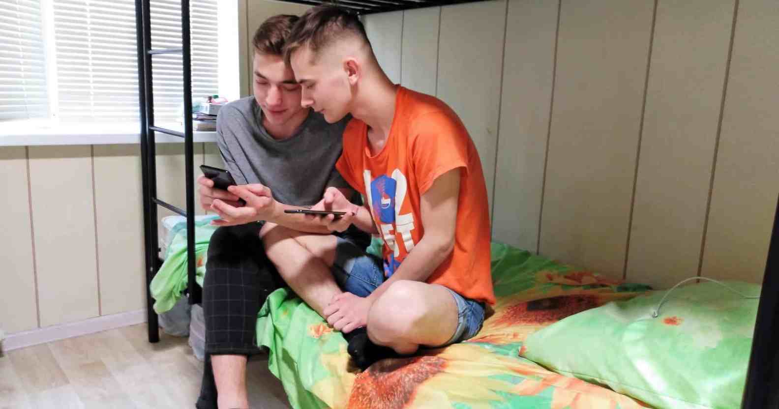Two men sitting on a bunk bed in an LGBTQ+ shelter in Ukraine.