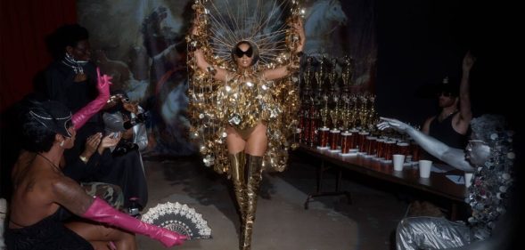 Beyoncé in a gold ballroom inspired outfit.