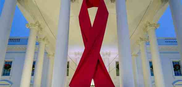 A large red ribbon is seen on the White House